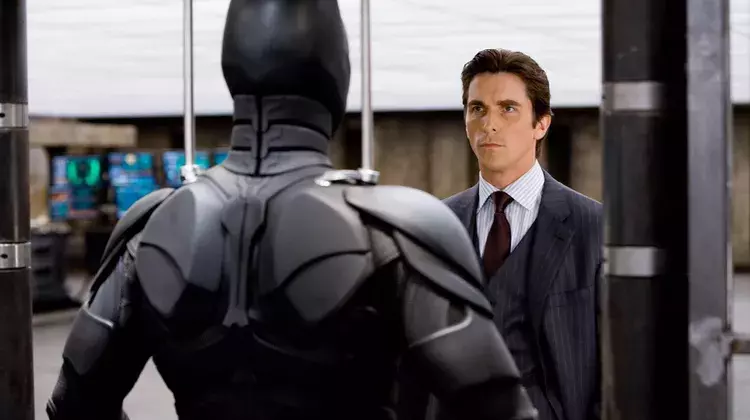 Bruce Wayne looking at Batman.